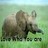 Pixelated image of two brown animals with horns standing on green grass under a light blue sky, with partial text at the bottom.