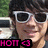 Pixelated image of a person with dark hair wearing white-framed sunglasses, standing near a vehicle with green foliage in the background, and a black banner with pink text at the bottom.