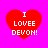 Four red heart shapes on a bright pink background, each containing white pixelated text reading "I LOVEE DEVON!" with varying degrees of pixelation.