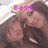Two people with long brown hair pose closely together in a pixelated image with changing text overlays.
