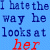 Blue background with pixelated text reading "I hate the way he looks at her" in dark blue and red, where 'her' and 'heart' are red.