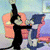 Animated cartoon cat and dog in a room with orange chairs and blue couch, performing sequential actions.