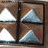 six triangular studs on a brown background with one frame showing a black star symbol replacing the bottom-right stud