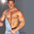 Static pixelated image of a shirtless muscular man in a white tank top against a gray background, with visible body contours and partial facial features.