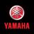 Circular Yamaha logo with red and white gradient on dark background, below which is bold red text reading YAMAHA.