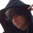 Pixelated image split into four quadrants with blue, gray, and black sections containing text and a person in a hooded garment.