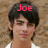 A single anime-style character with dark hair and a white shirt appears in three distinct text configurations against a brown textured background.
