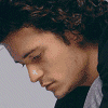 A sequence of showing a person with curly brown hair in various poses, transitioning from standing to crouching