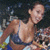 Pixelated figure in light-colored top and dark shorts against a dark background with scattered colored pixels.
