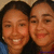 Two people with dark hair smiling closely together in a pixelated static image.