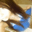 A person with long brown hair and blue clothing appears in a of four , with the bottom-right showing a gray background