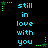 Pixelated cyan text "still in love with you" arranged in a with green star-shaped accents on a black background