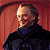 Pixelated static image of a person in dark clothing against a reddish background with visible dithering and low-resolution rendering artifacts.
