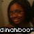 A person with dark hair and glasses wears a white tank top, smiling in front of a light-colored wall; text overlay reads "dinahboo".