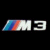 Static pixel art icon featuring stylized 'M' and '3' characters with diagonal blue-to-red gradient stripe on left, white fill for letters, black background.