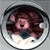 Circular icon with brown hair and pink face showing blue eye and white mouth, animated to shift blue eye position