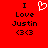 Red background with black text reading "I Love Justin <3" and a white pixelated heart symbol above the word "Love".