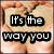 six showing hands forming a heart shape with sand, overlaid with text reading "It's the way you make me LAUGH when I don't even want to SMILE"