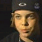 Two side-by-side pixelated images of a person wearing a dark cap with white and gray symbols, one featuring a red heart above the head.
