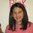 A person with long dark hair wearing a pink top appears in three showing subtle facial expression changes against a light background with partial red text