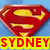 A red shield-shaped emblem with a yellow 'S' symbol on blue background, below which is a yellow banner with red text reading "SYDNEY".
