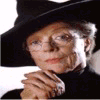 A 2x2 contact sheet of a static image featuring an elderly woman in black attire with a wide-brimmed hat and glasses, alongside text about 'Predictions Misconceptions & Transfiguration' by Mascaret as part of 'The unauthorized Biography of Minerva McGonagall'.