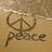 A static image showing a beach scene with sand, water, and two distinct drawings: one of a peace symbol followed by the word 'peace' written in the sand, and another of a heart shape drawn on the sand.