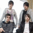 Four individuals pose together on a light background with yellow text listing names and "Panic! At THE Disco" on a black background.