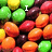 A pixelated image of colorful candy-coated chocolates with overlaid text reading "I Love SKITTLES!!!!!!" in white block letters.