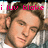 Pixelated image of a person with brown hair wearing a white shirt, overlaid with pink text reading 'i luv blake' at the top.