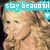 A pixelated image shows a person with light brown hair and fair skin, wearing a dark necklace against a blurred background. A cyan banner at the top displays 'stay beautiful' in white block letters.