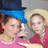 Two people in a pixelated image with text overlays; one wears a blue top hat, the other a straw hat and red shirt.