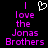 Pixelated text reads "I love the Jonas Brothers" in purple with a white heart symbol above the 'I' on a black background.