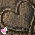 Two side-by-side heart-shaped objects with textured brown surfaces and pink pixelated hearts at the bottom left of each, set against a gray background.