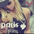 Pixelated image of a person with light hair wearing dark clothing, holding a white heart-shaped object near their chest.