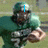 A football player in a green uniform holding a ball, with blue text overlays changing across frames.