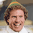 A pixelated image of a smiling person with curly brown hair wearing a green and orange striped hat, set against a blue background with yellow text reading "IT'S SANTA!" and "OMG!!".