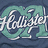 Pixelated icon with stylized white text on a teal and dark blue background, featuring curved shapes and abstract forms.