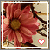 A pixelated flower with pink petals and a brown center, framed by dark branches against a beige background, featuring a small heart symbol at the bottom right.