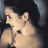Static 48x48 pixel icon showing a close-up of a person's face with light skin tone, dark hair, and visible ear against a dark background with blue-gray side elements.