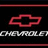 A static digital image with a split composition: left side shows a red Chevrolet bowtie logo above 'CHEVROLET' text on black background; right side displays cyan pixelated text about oxymorons and examples like 'JumboShrim| Living DeadFORD TOUGH Freezerburr' on blue background.
