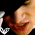 Pixelated close-up of a person's face with closed eyes and red lips, next to a white anchor symbol on black background.