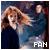 Two pixelated figures with light hair and dark clothing stand against a blurred background, one figure extending an arm toward the other while white text reads "FAN" at bottom right.