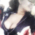 Pixelated static image of a character with dark hair and a black outfit, showing a partial view of the face and upper body against a light background.