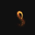 Golden particle trails form various curved shapes against a black background, transitioning from small spirals to larger arcs and loops.