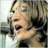 A 48x48 pixel animated buddy icon featuring a side-profile of John Lennon singing into a microphone on the left frame and green text reading "Original Icons .com" on the right frame, displayed as a contact sheet with two sampled frames.