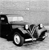 Black and white pixelated image of a vehicle with visible wheels and a body, set against a light gray background.