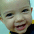 A child's face in a with four , showing consistent smiling expression and clothing across visible sections