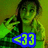 A person in a green jacket makes a hand gesture with fingers extended, while a blue and yellow '<33' symbol appears over the lower-left portion of the image.