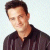 Pixelated static image of a person with short dark hair wearing a dark collared shirt against a light background.